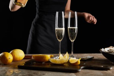selective focus of champagne glasses with sparkling wine near woman isolated on black  clipart