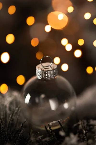 Close Transparent Christmas Ball Spruce Branches Snow Yellow Lights Bokeh — Stock Photo, Image