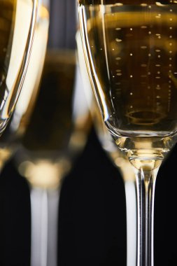 close up of glasses with champagne for celebrating christmas, isolated on black  clipart