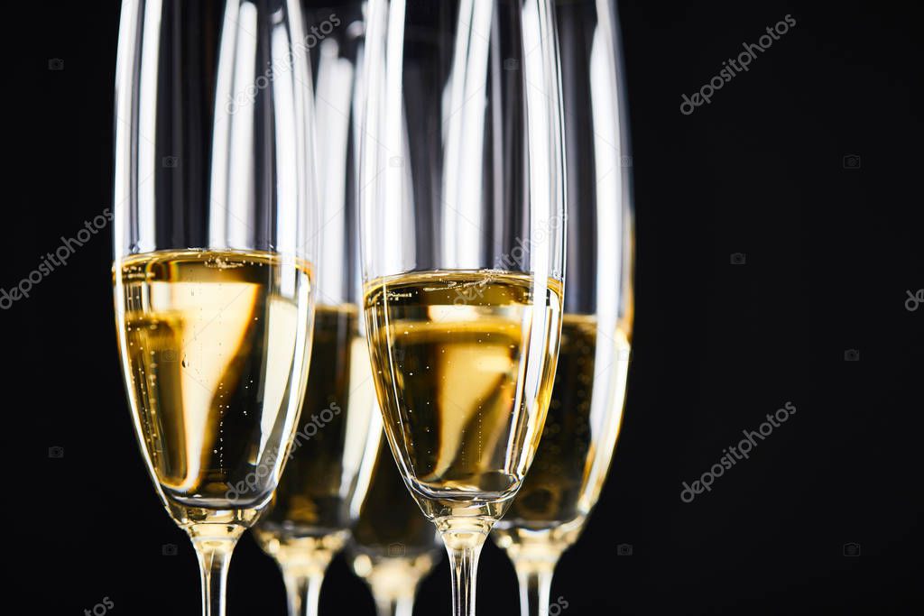 close up of champagne glasses for celebrating christmas, isolated on black 