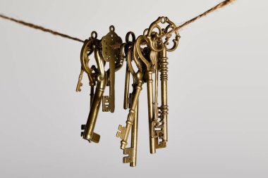 vintage keys hanging on rope isolated on white clipart