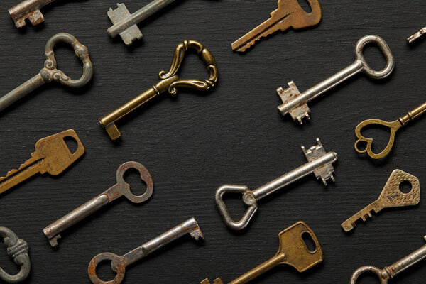 top view of vintage rusty keys on violet background