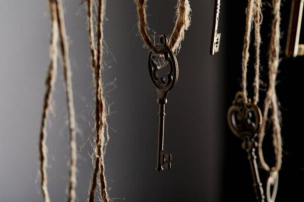 close up view of vintage keys hanging on ropes