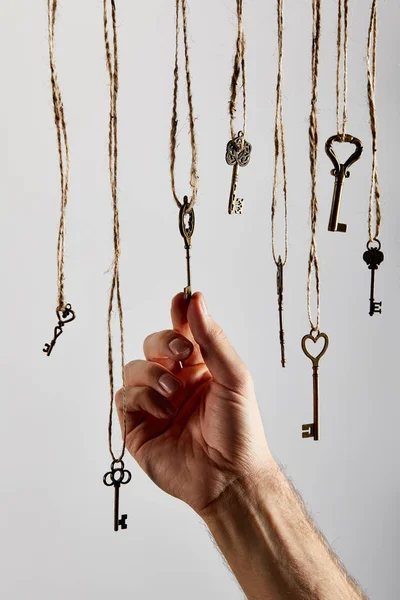 Cropped View Man Touching Vintage Keys Hanging Ropes Isolated White — Stock Photo, Image