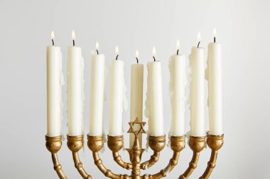 burning candles in menorah on Hanukkah isolated on white clipart