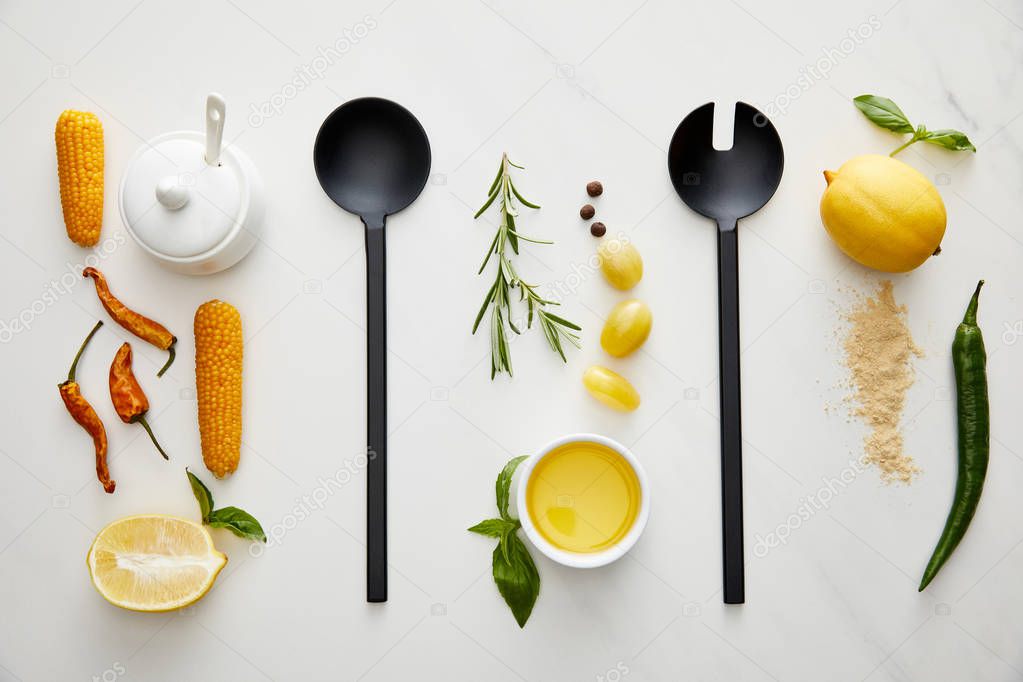 Top view of kitchenware, vegetables and herbs on marble background