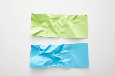 top view of empty crumpled blue and green paper on white background clipart