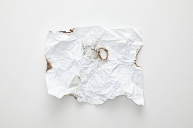 top view of empty crumpled and burnt vintage paper on white background clipart
