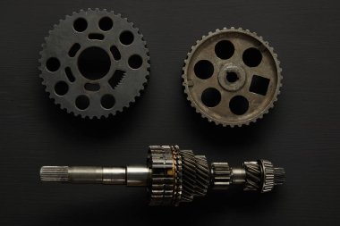 top view of aged gears on black surface clipart
