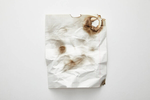 top view of empty crumpled and burnt vintage paper on white background