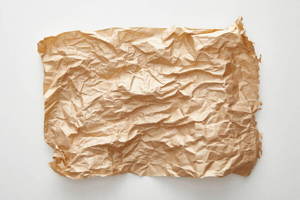 top view of empty crumpled craft paper on white background
