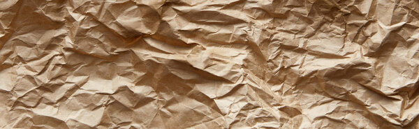 top view of empty beige crumpled craft paper texture, panoramic shot
