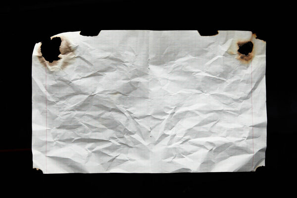 top view of empty white crumpled and burnt vintage paper isolated on black
