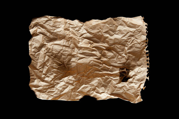 top view of empty crumpled and burnt vintage paper isolated on black