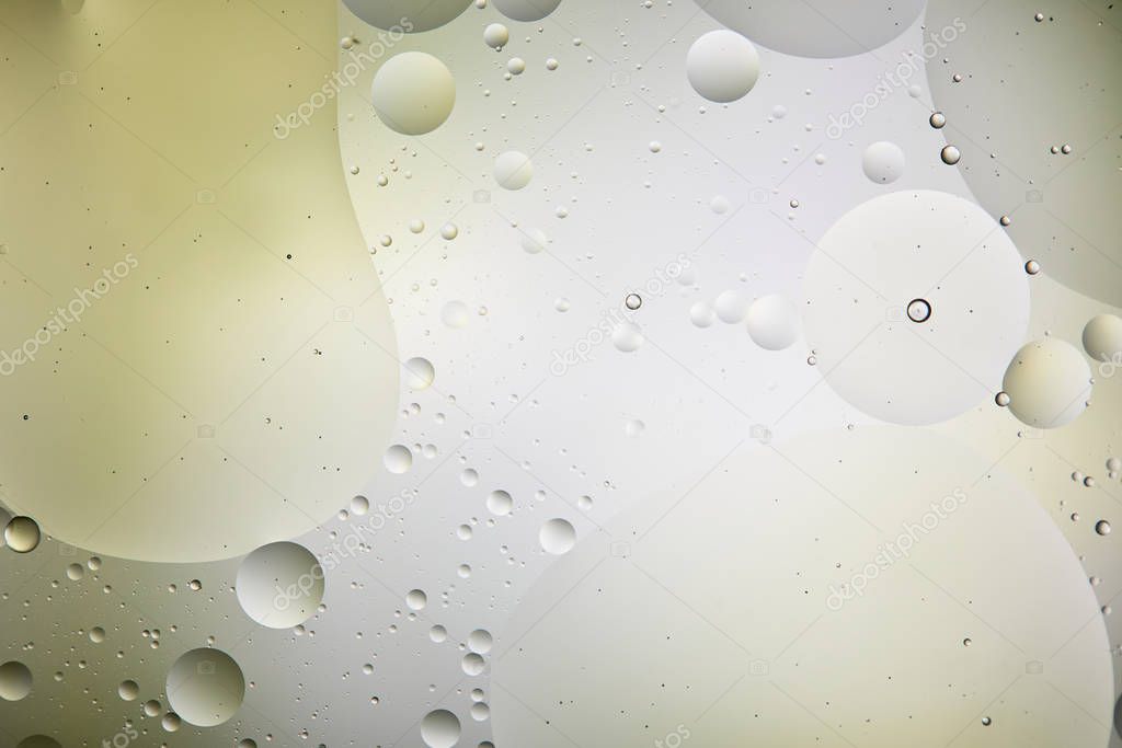 creative light green and grey color background from mixed water and oil bubbles 