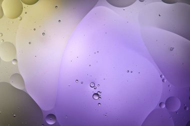creative purple and green color abstract background from mixed water and oil bubbles clipart