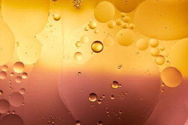 Beautiful abstract background from mixed water and oil in orange and pink color clipart