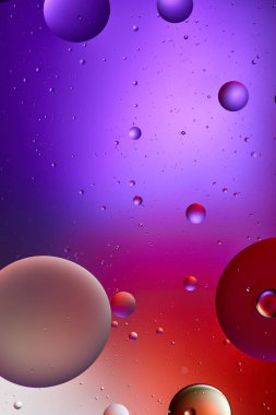 creative abstract purple and red color texture from mixed water and oil bubbles clipart