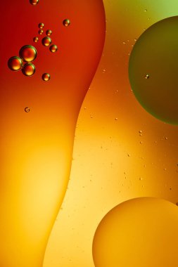 Beautiful abstract orange, red and green color background from mixed water and oil  clipart
