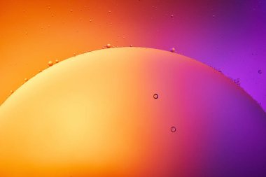 Beautiful abstract background from mixed water and oil in orange, red and purple color clipart