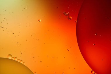 Beautiful abstract background from mixed water and oil in orange and red color clipart