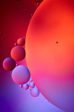 Beautiful abstract background from mixed water and oil bubbles in pink and purple color clipart