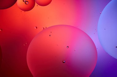 creative abstract background from mixed water and oil bubbles in pink and purple color clipart