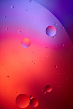 creative texture from mixed water and oil bubbles in pink and purple color clipart