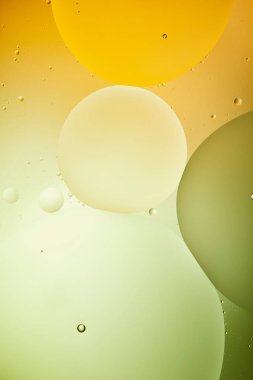 Beautiful green and orange color abstract background from mixed water and oil clipart