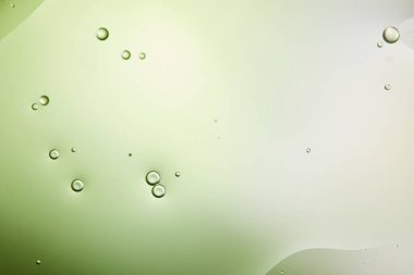 abstract background from mixed water and oil in light green color clipart