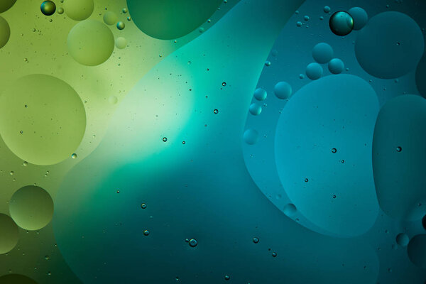 Красивый абстрактный фон из смешанной воды и масла в синем и зеленом цвете
