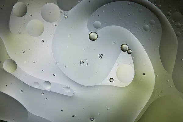 Beautiful abstract background from mixed water and oil in light green and grey color