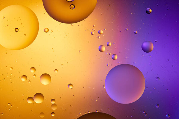 Beautiful abstract background from mixed water and oil in orange and purple color