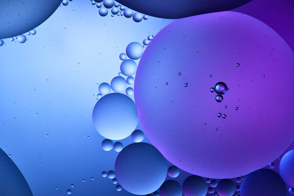Beautiful abstract background from mixed water and oil in blue and purple color