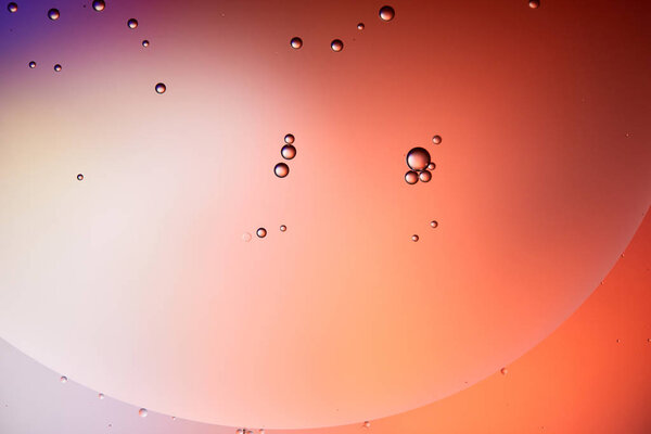 abstract background from mixed water and oil bubbles in red color