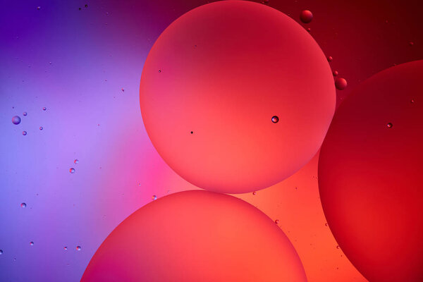 Beautiful abstract background from mixed water and oil bubbles in pink and purple color