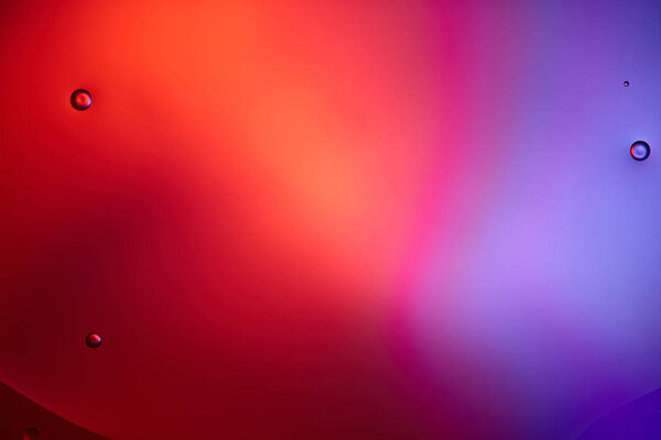 abstract background from mixed water and oil bubbles in pink and purple color