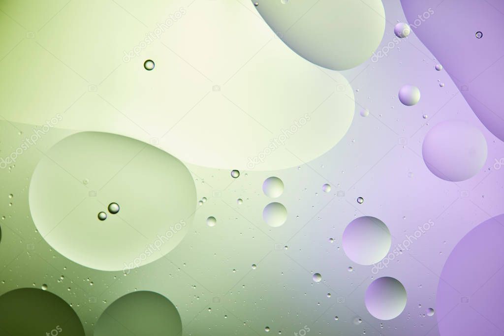 abstract background from mixed water and oil in light green and purple color