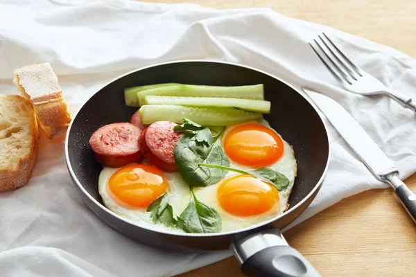 Fried Eggs Frying Pan Spinach Cucumber Sausage Wooden Table Cutlery — Stock Photo, Image