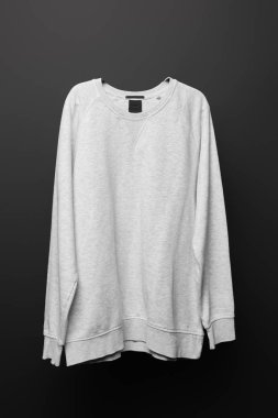 blank basic grey sweatshirt isolated on black  clipart