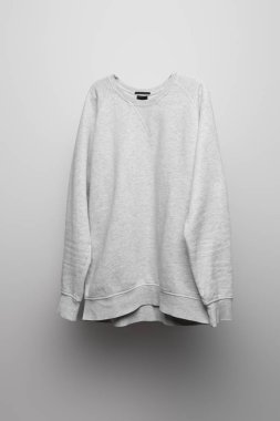 blank basic grey sweatshirt on grey background clipart