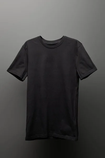 blank basic black t-shirt on grey background