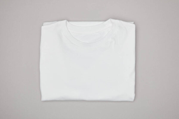 top view of blank basic white t-shirt isolated on grey