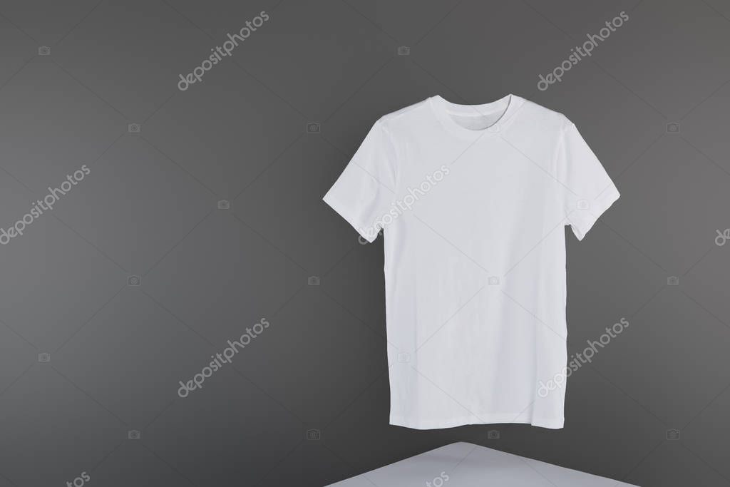 Blank basic white t-shirt on grey background