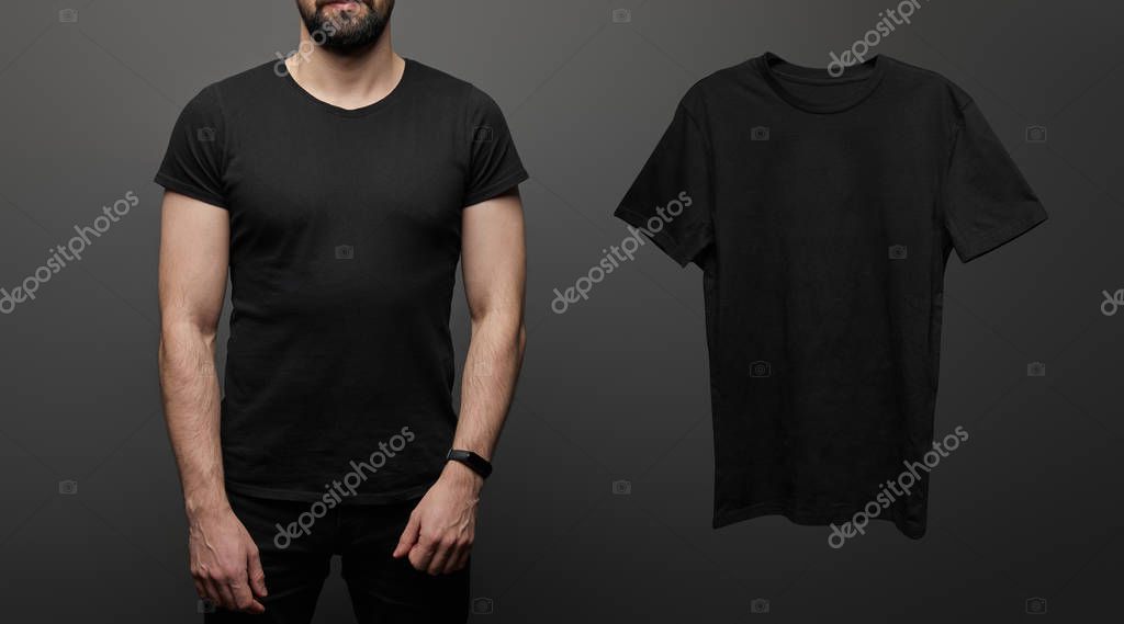 Cropped view of bearded man near blank basic black t-shirt on black background
