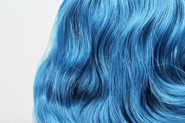 Close up view of blue colored hair isolated on white