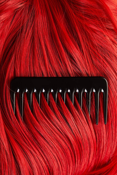 Top view of comb on colored red hair 