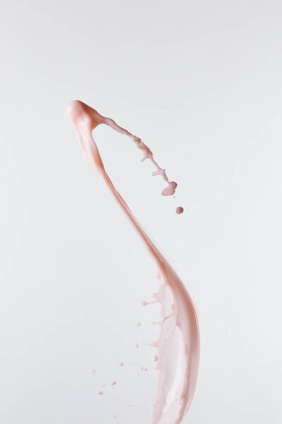 fresh pink milk splash with drops isolated on white
