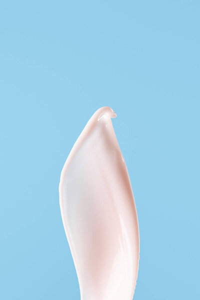 smooth fresh pink milk splash isolated on blue