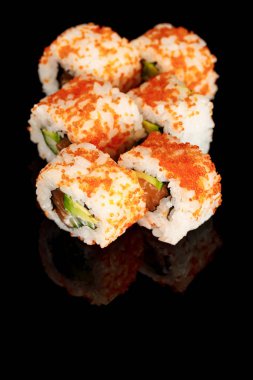 delicious California roll with avocado, salmon and masago caviar isolated on black clipart